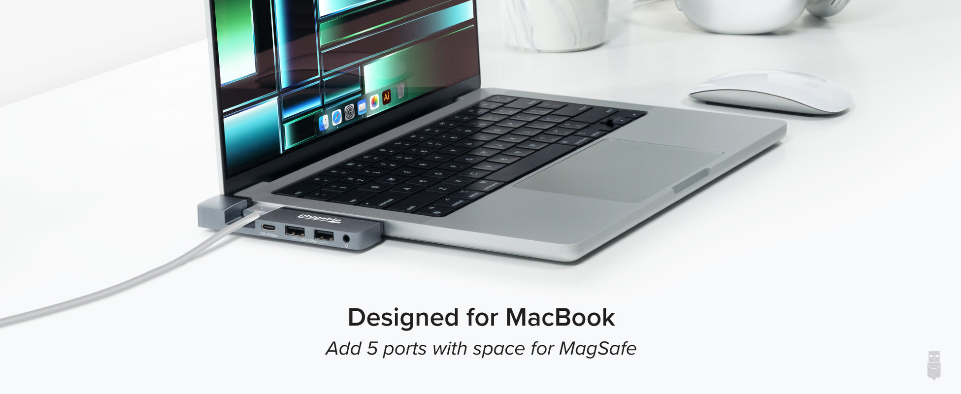 An image of the AMS-5IN1E connected to a MacBook while the MagSafe charger is connected. 