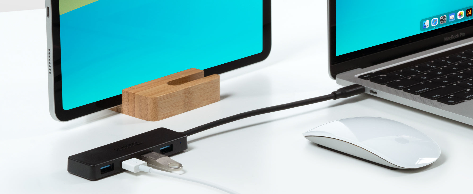 The USBC-HUB4A connected to a laptop with a Thumb drive and other USB device attached.