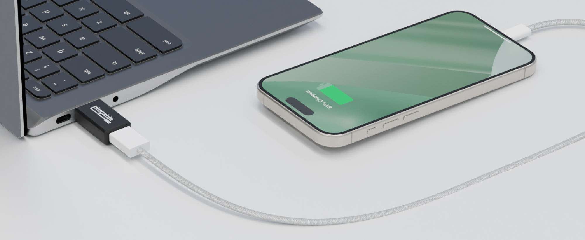 An image of a mobile phone plugged into a computer using a Plugable USB-MC1 adapter.