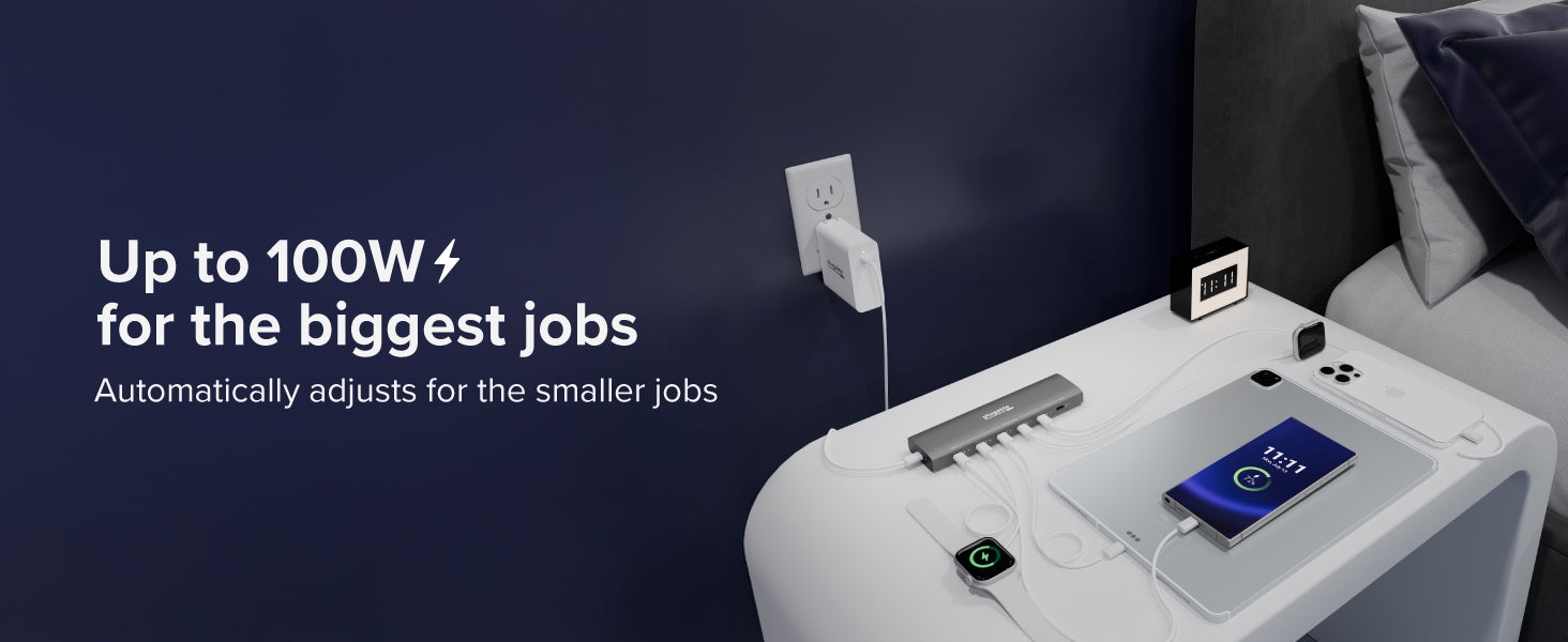 USB charging station by the bed powers laptop, phone, smartwatch, and other mobile devices
