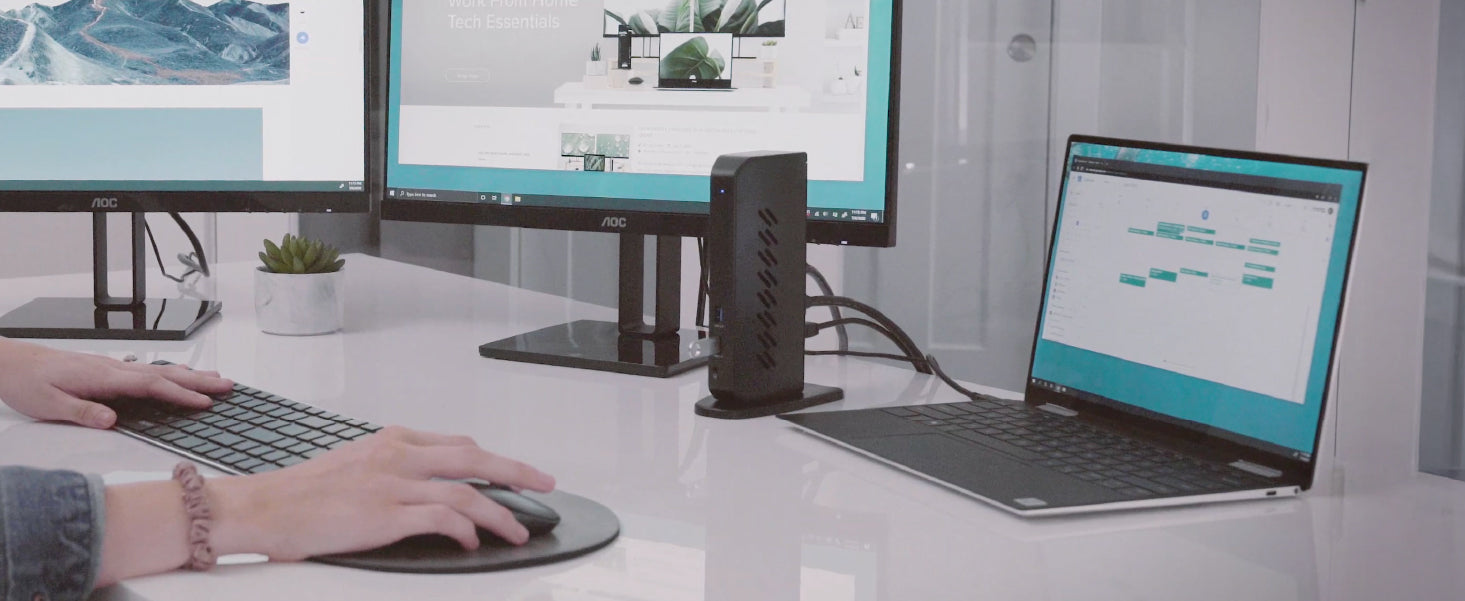 UD-6950Z docking station connected to a laptop on a desk with two monitors